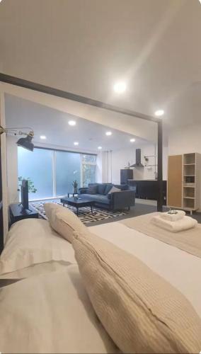 a living room with a large bed and a couch at Beautiful studio near the station in London