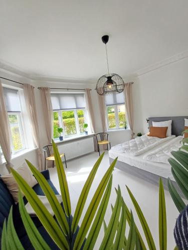 a bedroom with a bed and a potted plant at Exclusive Luxury Apartment in the Heart of Aalborg in Aalborg