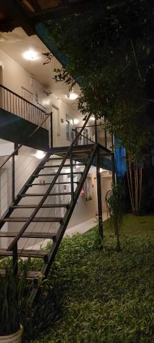 a staircase in a building with a tree in front of it at Ecopousada Miriti in Belém
