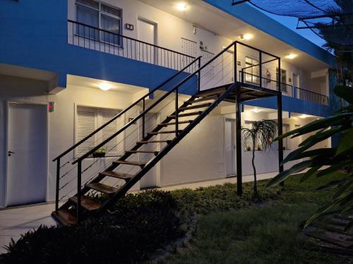 a staircase in front of a house at night at Ecopousada Miriti in Belém