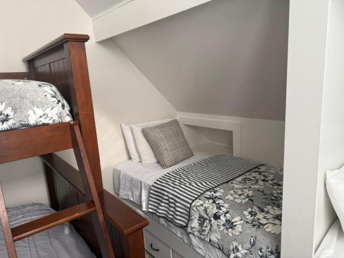 a small bedroom with a bunk bed and a ladder at Tamarack Retreat Donnelly ID in McCall