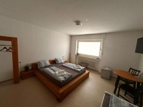 a bedroom with a large bed and a table at Das Gerhards in Wolfhagen