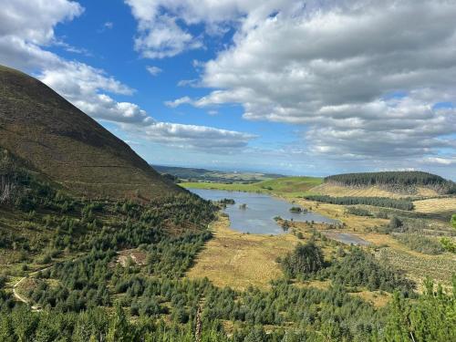 an aerial view of a river between two mountains at Cumbric Cottage - Cosy Lake District Escape in Lamplugh