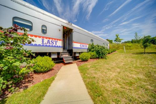 a train is parked next to a sidewalk at The Artiste, Converted Railcar in DuBois! in Adrian Furnace