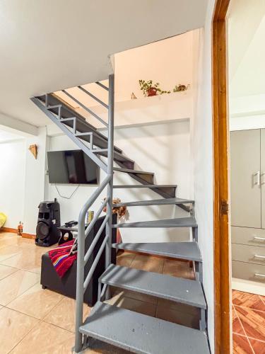 a metal staircase leading up to a loft apartment at Los Chullos in Cusco