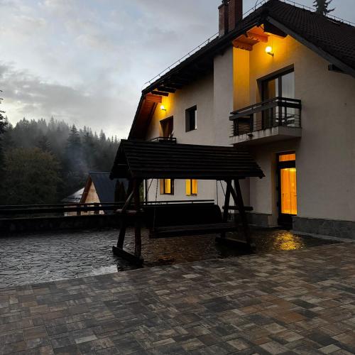 a large building with a porch on the side of it at Vila Daria in Braşov