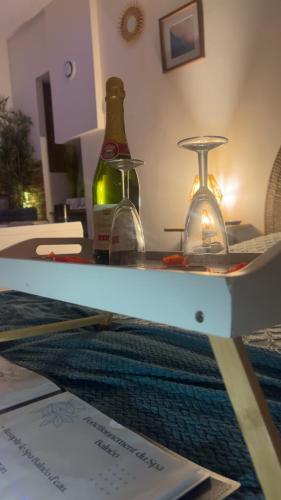 a table with two bottles of wine on it at Nuit Magique en Love Room avec Jacuzzi Privé in Vierzon