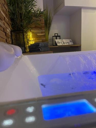a close up of a tub of water in a room at Nuit Magique en Love Room avec Jacuzzi Privé in Vierzon
