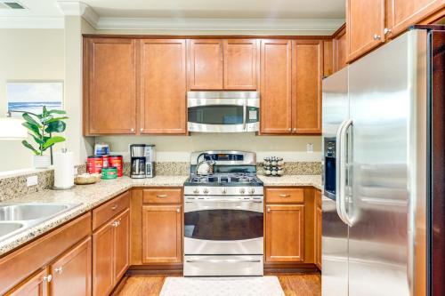 a kitchen with wooden cabinets and stainless steel appliances at Mountain Views Reno Home 6 Mi to Downtown! in Reno