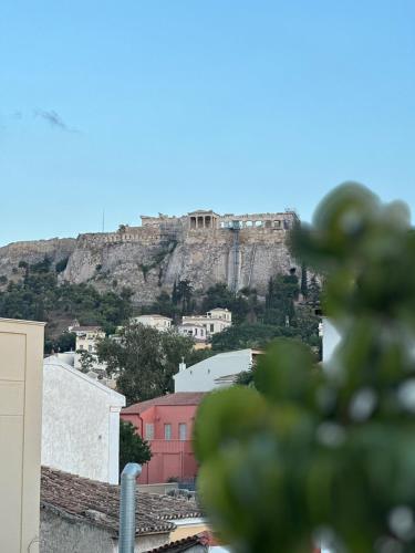 a view of a hill with a castle on top at Theasis Athens in Athens