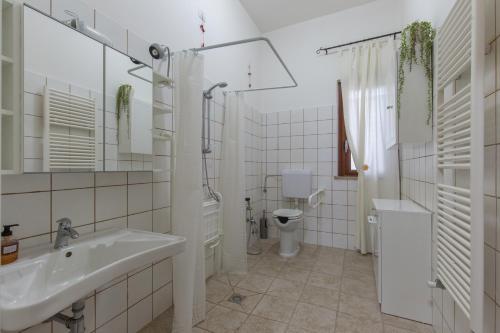 a white bathroom with a sink and a toilet at Selene BeB in Casalbordino