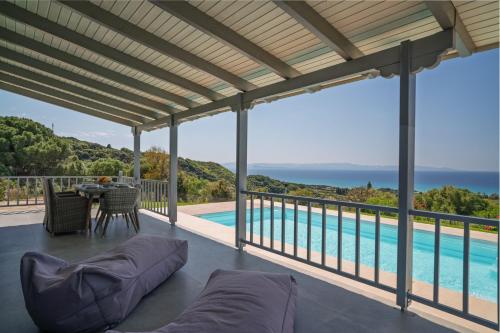 a view from the deck of a house with a pool at Villa Filokalia With Exceptional View - Happy Rentals in Kastro Kyllini