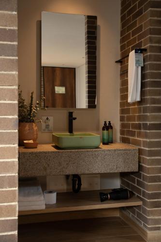 a bathroom with a sink and a mirror at Casa Rose Hotel in Carmen de Viboral
