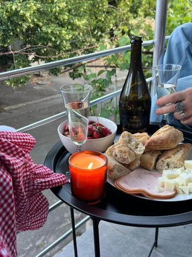a table with a plate of food and a bottle of wine at Hotel Graif Ti in Tbilisi City