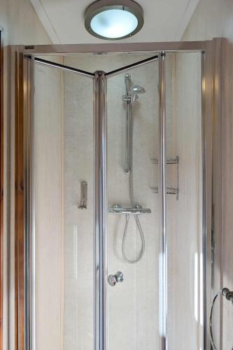 a shower with a glass door in a bathroom at The Castle Inn in Wigmore