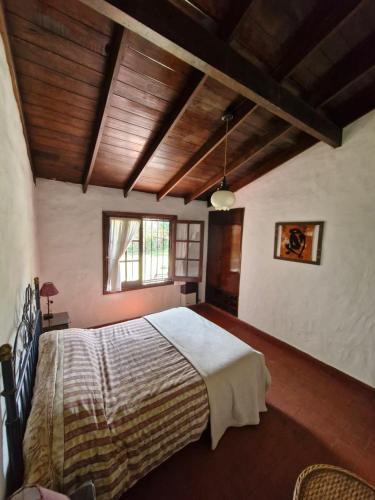 a bedroom with a large bed in a room at Chuhouse in Villa Gesell