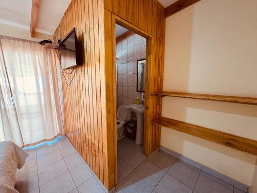 a small bathroom with a toilet and a mirror at hostal camino del inca in San Pedro de Atacama
