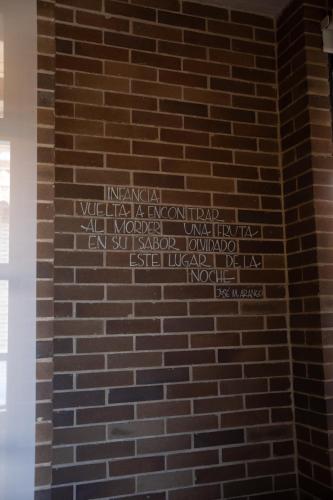 a brick wall with writing on it at Casa Rose Hotel in Carmen de Viboral