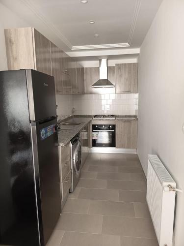 a kitchen with a black refrigerator and a dishwasher at Le Hammamet centre in Hammamet