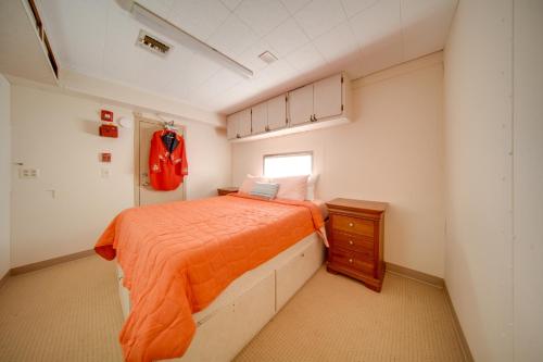 a bedroom with a bed and a dresser and a window at The Ringmaster, Converted Railcar in DuBois! in Adrian Furnace