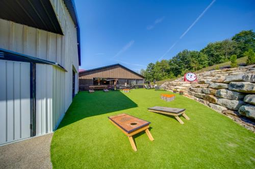 a yard with two picnic tables and a stone wall at The Ringmaster, Converted Railcar in DuBois! in Adrian Furnace