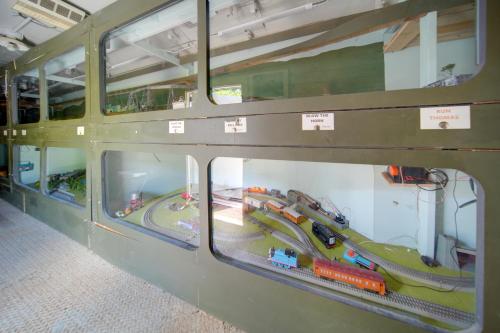 a display case with toy trains in a bus at The Ringmaster, Converted Railcar in DuBois! in Adrian Furnace
