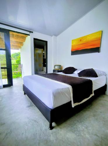 a bedroom with a large bed in a room at Betania Alojamiento Rural Quindío Eje Cafetero espectacular! in Circasia