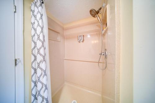 a bathroom with a shower with a shower curtain at Choo Choo Blue, Converted Railcar in DuBois! in Adrian Furnace