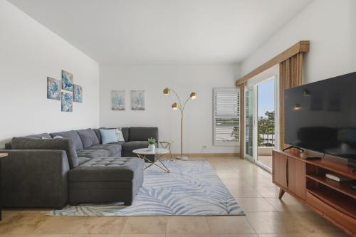 a living room with a couch and a flat screen tv at Royal Sea Cliff Kona by OUTRIGGER - Select Your Unit in Kailua-Kona