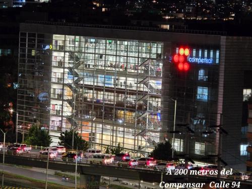 a building with a red traffic light in front of it at Hotel Castellana 100 Bogota By Hoteles Confort 80 in Bogotá