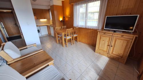 an overhead view of a living room and kitchen with a television at Centre Thermal - Studio SUD terrasse in Ovronnaz