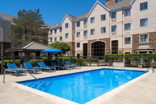a swimming pool in front of a building at Staybridge Suites Boston - Burlington by IHG in Burlington