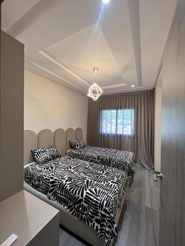two beds in a bedroom with zebra at Cozy apartment Beach and Souk within walking distance in Tangier