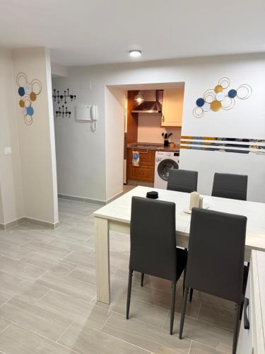 a kitchen and dining room with a table and chairs at El Boulevard de Trujillo 1997 in Trujillo