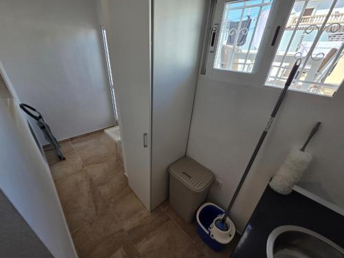 a small bathroom with a toilet and a window at "Ancla-Blanca" Ocean View Duplex 2min Beach Cabo Roig - La Zenia in Orihuela Costa