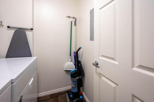 a bathroom with a door with a broom and a vacuum at Relaxing Place Close to Skiing in Midvale