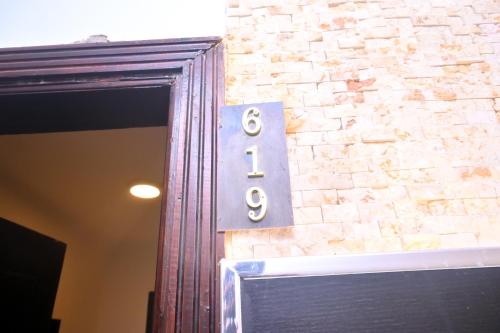 a house number on the side of a brick wall at New Alhussien Hotel in Asyut