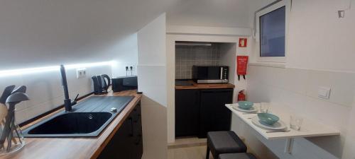 a small kitchen with a sink and a counter at Casa Da Severa Apartments in Lisbon