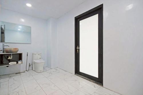 a bathroom with a door leading to a toilet at House16 in Green Island