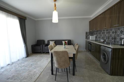a kitchen with a table and chairs in a room at Iskele Royal Sun Long Beach penthouse in Iskele