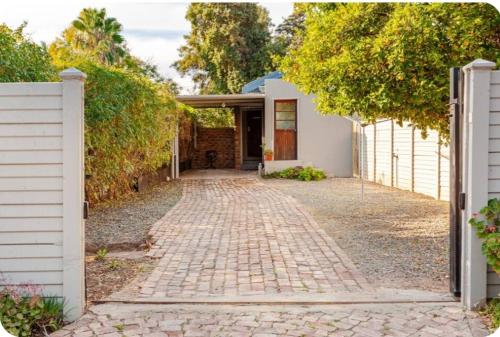 a brick driveway in front of a house at Self-catering Garden Cottage in Oudtshoorn