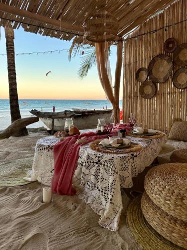 a restaurant on the beach with two tables at Poa Poa Bungalows in Kiwengwa