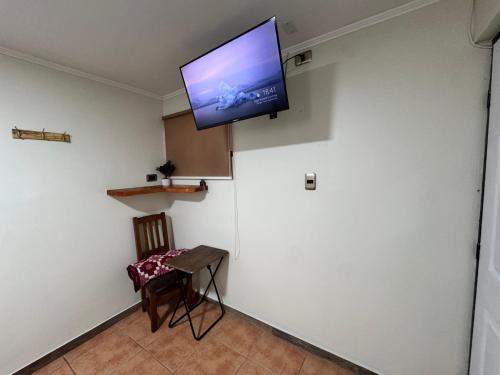 a room with a flat screen tv on a wall at Residencial Don Santiago in Talca