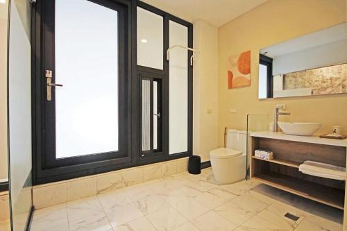 a bathroom with a sink and a toilet and a window at House16 in Green Island