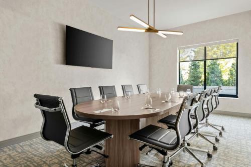 a conference room with a large table and chairs at Residence Inn by Marriott Melville in Melville