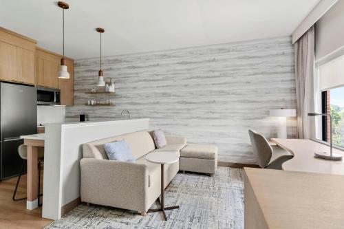 a living room with a couch and a table at Residence Inn by Marriott Melville in Melville