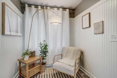 a living room with a chair and a window at Euro Cottage - Downtown Convenience BBQ Fire Pit in Colorado Springs