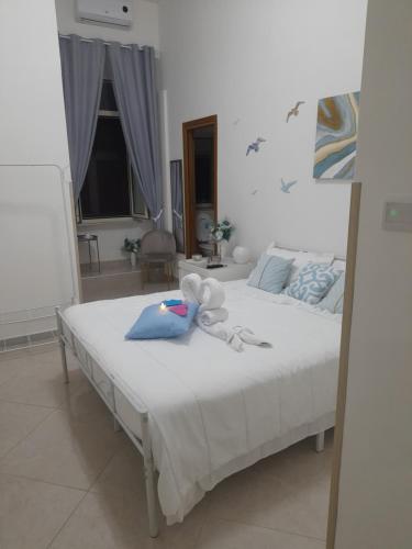 a bedroom with a bed with a stuffed animal on it at Falanga Family Guests Accommodation in Civitavecchia