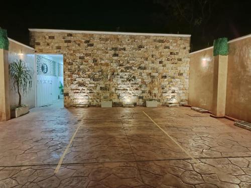 a room with a stone wall and a stone floor at Chan Kiin Departamentos in Valladolid