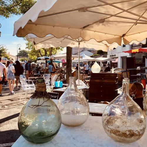 three glass vases sitting on top of a table at Au Romarin in Cavaillon